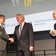 drei Männer auf der Bühne beim Neujahrsempfang