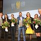 mehrere Personen mit Blumen auf der Bühne beim Neujahrsempfang