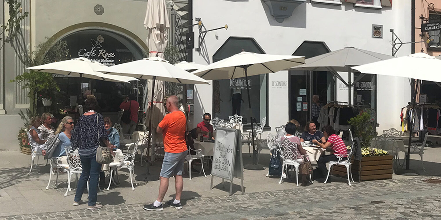 Außenansicht des Café Rose in Villingen-Schwenningen bei Sonnenschein mit Gästen.