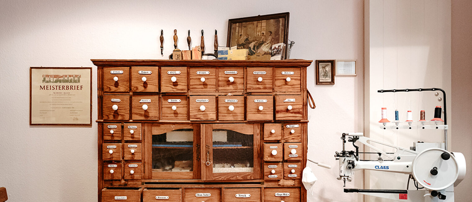 Alter Apothekerschrank in der Werkstatt eines Schuhmachers.