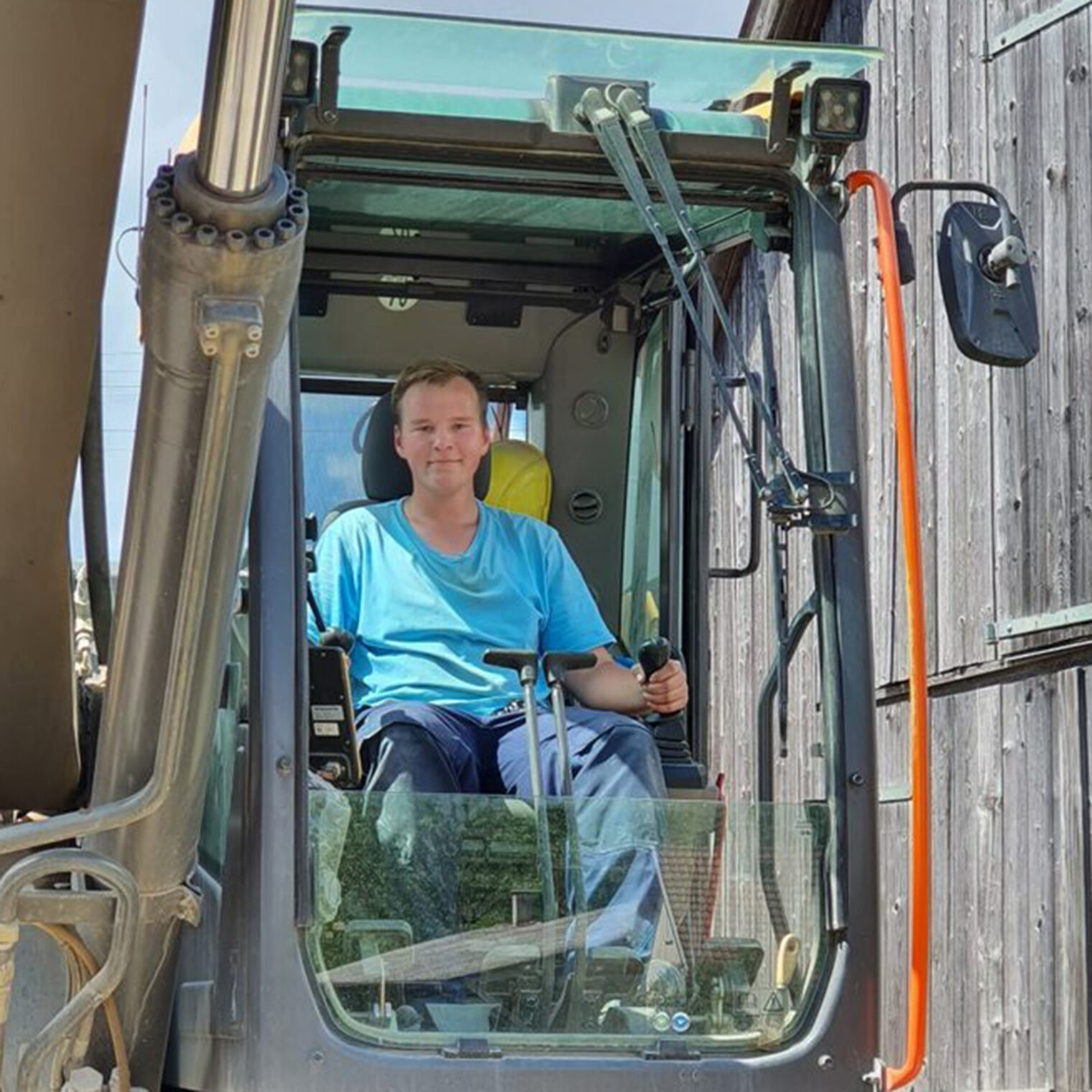 Portrait des jungen Straßenbauers Julian Burmistrack im Bagger.