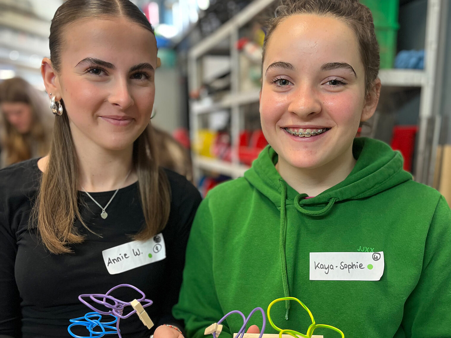 Zwei Schülerinnen präsentieren am Girls Day ihre selbstgefertigten Drahtblumen.