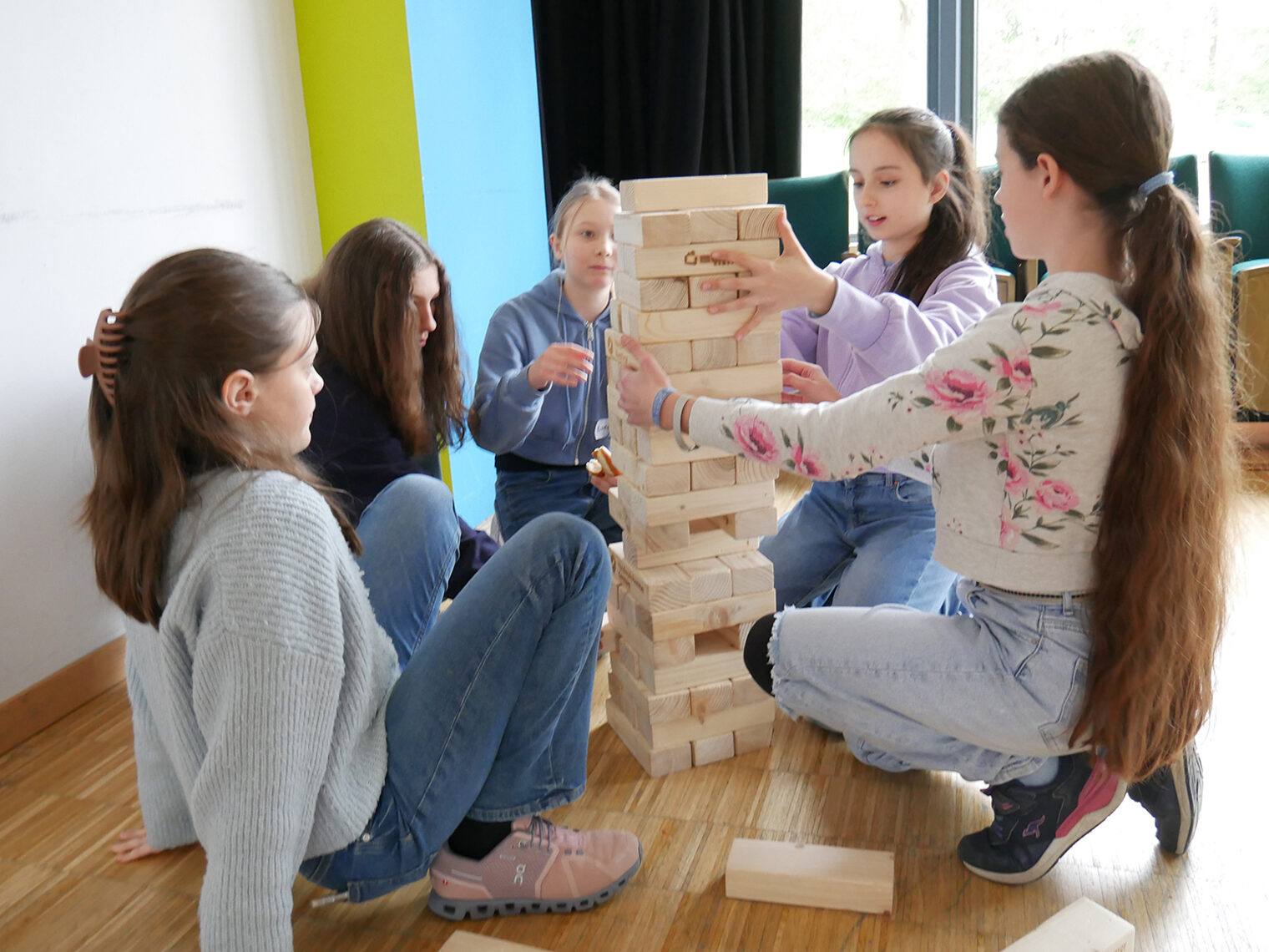 Schülerinnen bauen am Girls Day einen Turm aus Holz.