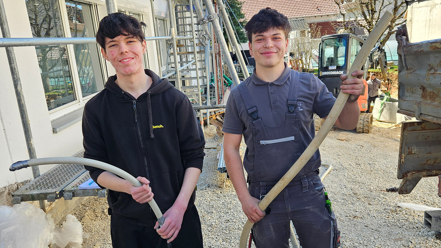 Praktikant und Auszubildender aus dem Elektrohandwerk auf der Baustelle.